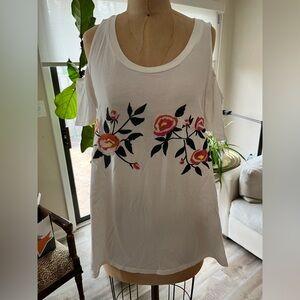 White tee, bare shoulders, embroidered flowers on front.  Sugar Lips size L